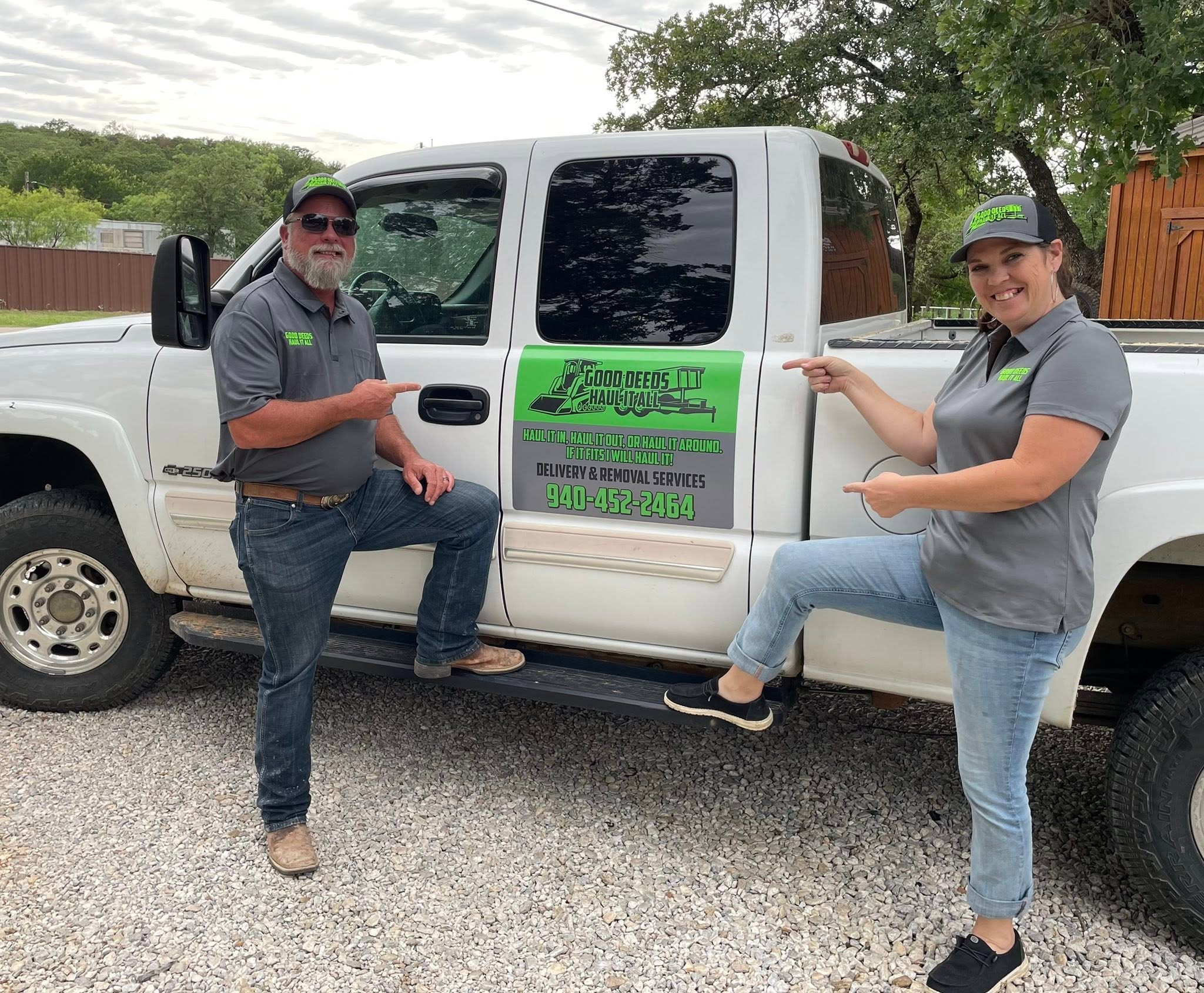 Eddie and Lorin Deeds standing with the Good Deeds Haul It All service truck