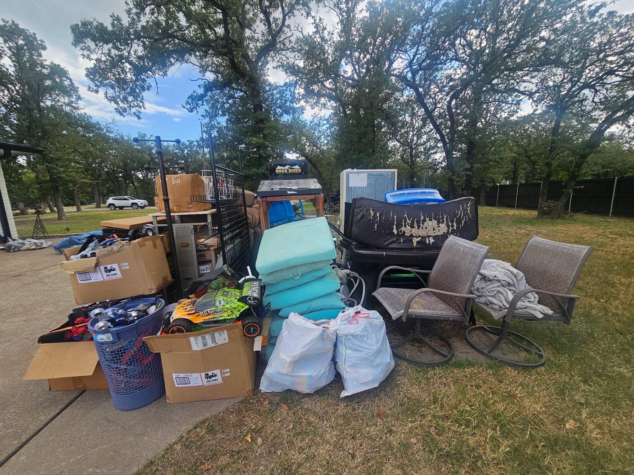 Furniture, boxes, and household items staged at the curb for junk removal pickup in the Mineral Wells area